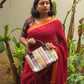 Sitara - Red Linen Saree with Copper Zari border